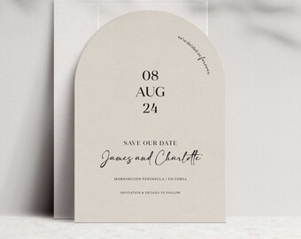May include: A beige save the date card with a rounded arch shape. The text reads "08 AUG 24" and "we've decided on forever". Below the date, it says "Save Our Date" and "James and Charlotte". The location is listed as "Mornington Peninsula | Victoria" and the bottom of the card says "Invitation & Details to Follow".
