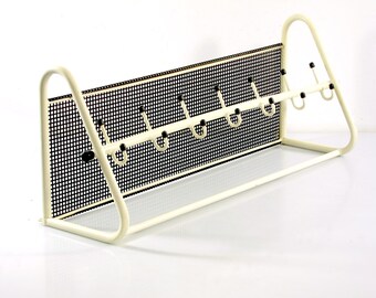 Original handy perforated sixties vintage Pilastro coat rack for hanging your clothes and hats in the passage