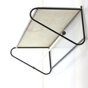Tasteful and timeless white and black 1950s perforated coat rack designed by Tjerk Rijenga for Pilastro