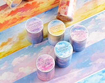 May include: Several rolls of decorative adhesive tape featuring printed sky and cloud patterns in various colors including orange, yellow, blue, and purple. Each roll has a circular label on top with the text Celestial Clouds printed on it.