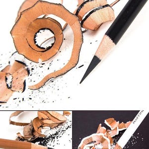 May include: Close-up of three sharpened pencils with wood shavings. The pencils are black, brown, and white. The shavings are curled and scattered around the pencils.
