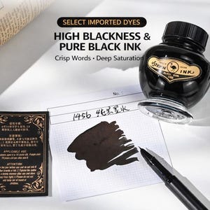 May include: A glass bottle of Ostrich brand black ink with a black screw cap and a label featuring an ostrich illustration. Next to it is a black fountain pen, a grid paper sheet with a black ink swatch, and a black box with gold text.