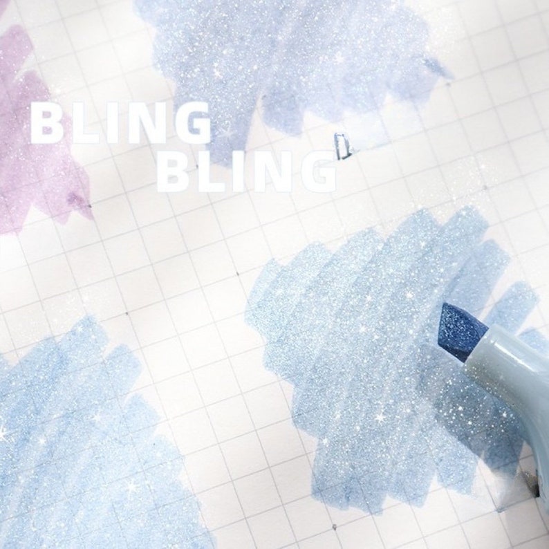 May include: Close-up of a light blue highlighter pen with a blue tip, creating a sparkling effect on a grid paper. The word "BLING" is written in white. The background features light blue and purple glittery brushstrokes.