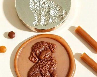May include: A circular metal wax seal stamp featuring an engraved curly-haired dog design, paired with a matching brown wax seal impression of the same dog, accompanied by several small brown wax beads and two brown wax sticks.