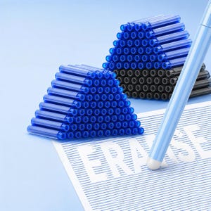 May include: A light blue pen with a white eraser tip rests on a white paper featuring the word ERASE in blue outline text. Behind the paper are two triangular stacks of translucent blue and black plastic pen ink refills arranged in rows.