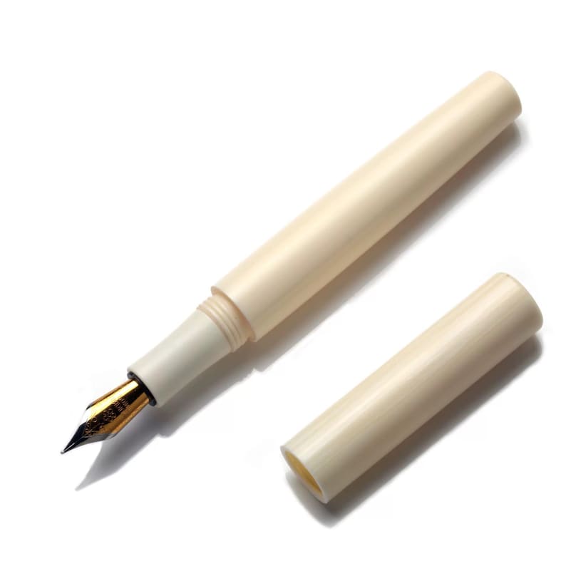 May include: A white fountain pen with a gold nib and a matching white cap. The pen is lying on a white surface.