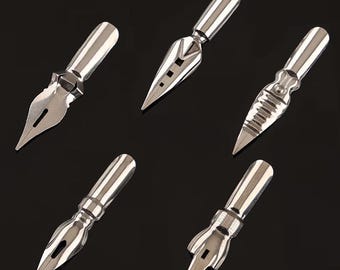 May include: A set of five silver-toned metal calligraphy pen nibs arranged in a scattered pattern. Each nib features a distinct shape, including pointed, ribbed, and slotted designs, all with a smooth, reflective finish and a cylindrical base.