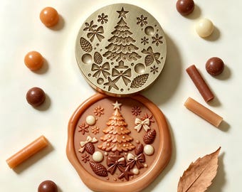 May include: A circular brass wax seal stamp featuring an engraved Christmas tree, snowflakes, bows, and pinecones. Below it, a light brown wax seal impression displays the same embossed design, surrounded by wax beads and sticks.