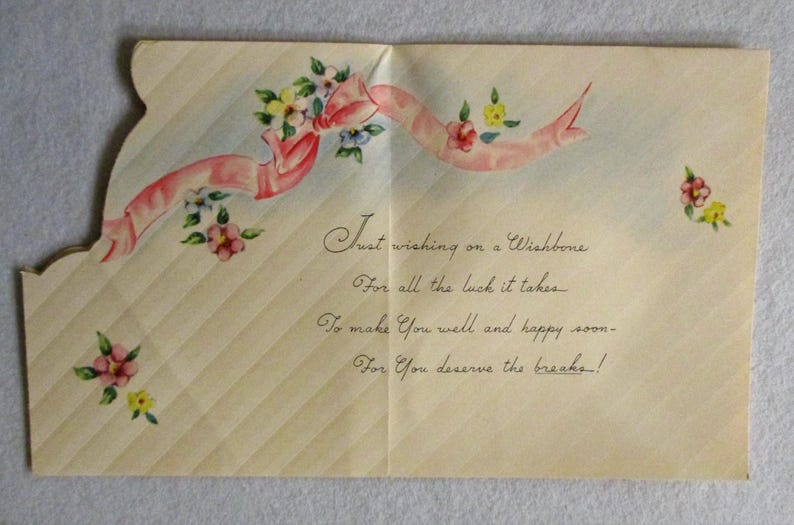 May include: A vintage-style greeting card with a cream-colored background featuring diagonal stripes. The card is decorated with a pink ribbon and small floral accents. The text reads: Just wishing on a Wishbone, For all the luck it takes, To make You well and happy soon, For You deserve the breaks!
