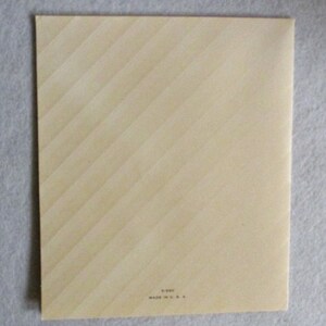 May include: A rectangular, cream-colored card featuring a subtle diagonal striped pattern across its surface. At the bottom center, small black text reads 5-597 and MADE IN U.S.A. The card has a clean, flat appearance with sharp, defined edges.