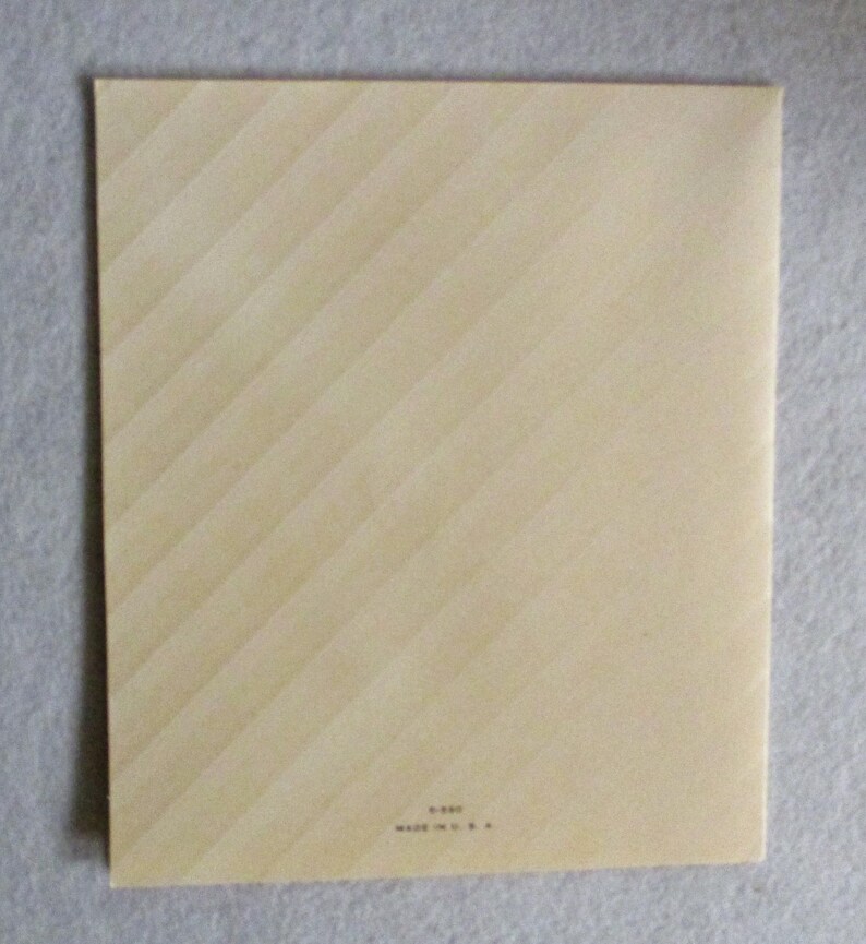 May include: A rectangular, cream-colored card featuring a subtle diagonal striped pattern across its surface. At the bottom center, small black text reads 5-597 and MADE IN U.S.A. The card has a clean, flat appearance with sharp, defined edges.