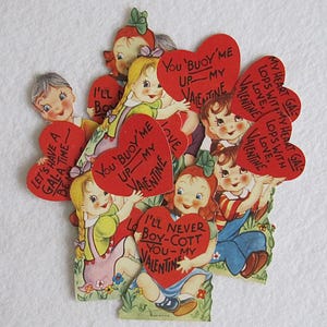 May include: Vintage Valentine's Day greeting cards featuring children holding red heart-shaped cards with romantic phrases. The cards have a retro style with illustrations of children in colorful clothing, perfect for a nostalgic gift.
