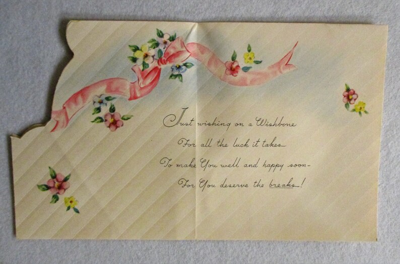 May include: A vintage greeting card with a cream-colored background featuring diagonal stripes. The card is decorated with a pink ribbon and small floral clusters in pink, yellow, and blue. The text reads: Just wishing on a Wishbone, For all the luck it takes, To make You well and happy soon, For You deserve the breaks!