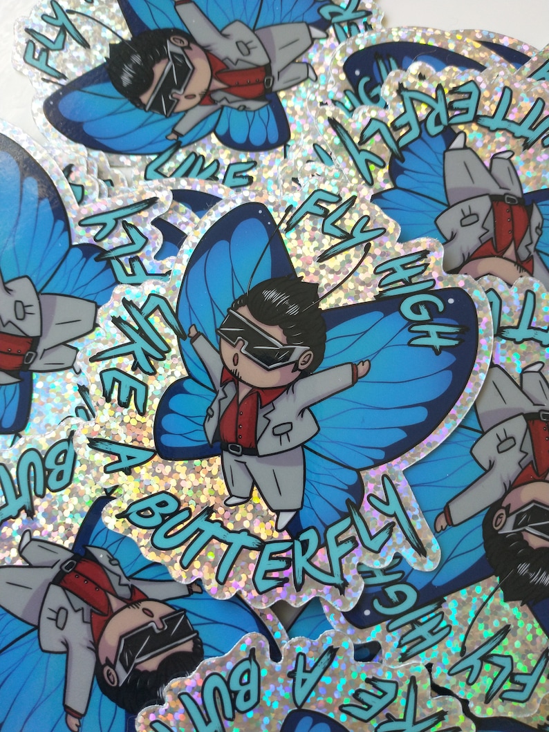 May include: A blue butterfly sticker with a cartoon character wearing a gray suit and sunglasses. The sticker has glitter and the text "Fly Like A Butterfly High"