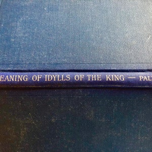 May include: A blue book with the title "Meaning of Idylls of the King - Pallen" printed on the spine.
