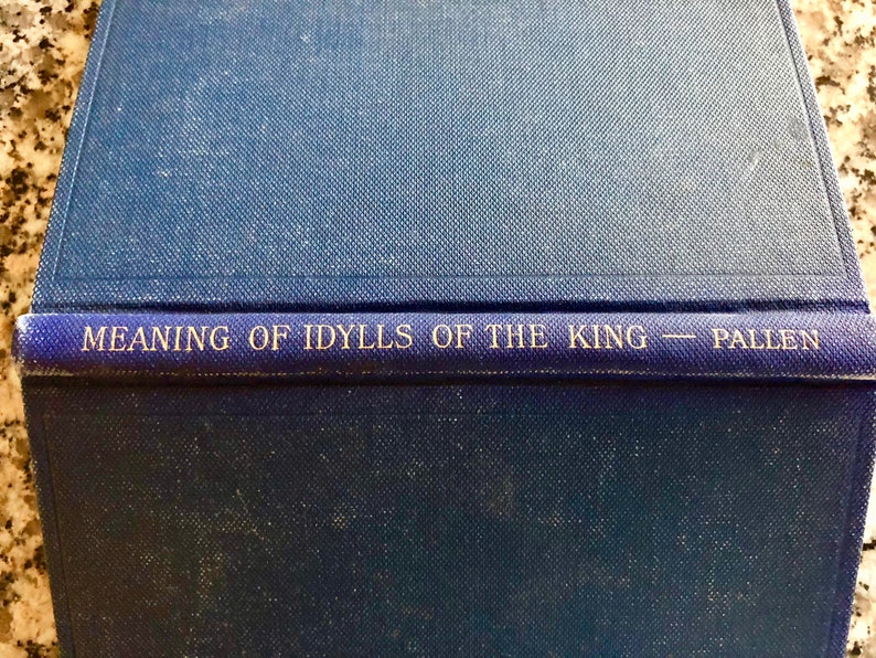 May include: A blue book with the title "Meaning of Idylls of the King - Pallen" printed on the spine.