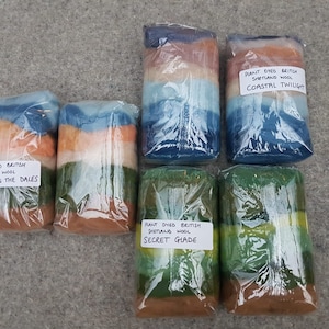 May include: Six individually wrapped bundles of plant dyed British Shetland wool. The bundles are labeled with the names "Dawn in the Dales", "Secret Glade", and "Coastal Twilight".