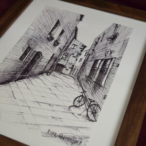 May include: Black and white ink drawing of a narrow street with buildings on either side. A bicycle is parked in the street. The drawing is signed "Sten Stromberg".
