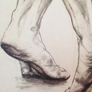 May include: A black and white pencil drawing of two bare feet, one foot is placed in front of the other, the feet are angled slightly inward, the drawing is signed "artbysuzann"