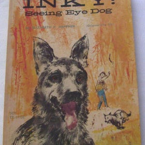 May include: Vintage book cover titled "INKY: Seeing Eye Dog" featuring a large illustration of a German Shepherd with its tongue out. The cover has a warm, orange and yellow background with a small illustration of a boy and another dog.