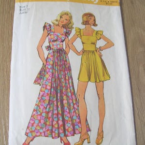 May include: Vintage Simplicity sewing pattern featuring illustrations of two dresses. One is a long, colorful patterned dress, and the other is a short yellow dress. The pattern is labeled "5670 Simplicity" with size and price information.
