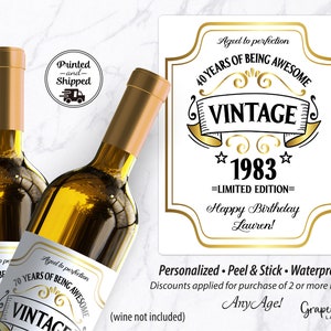 May include: Two gold wine bottle labels with a white background and gold text. The labels say "Aged to perfection 40 years of being awesome Vintage 1983 Limited Edition Happy Birthday Lauren!" and "Personalized. Peel & Stick. Waterproof. Discounts applied for purchase of 2 or more labels! Any Age!"