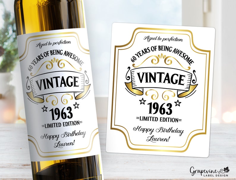 May include: A white wine bottle label with gold accents. The label says "Aged to perfection 60 Years of Being Awesome Vintage *1963* =Limited Edition= Happy Birthday Lauren!"
