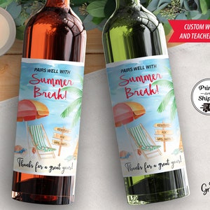 May include: Two wine bottle labels with a summer beach theme. The labels feature a beach umbrella, lounge chair, and the text "Pairs well with Summer Break!"  The labels are designed for teachers and include the text "Reserved for [Teacher's Name]" and "Thanks for a great year!"