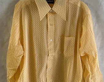 May include: A yellow long-sleeved button-down shirt with a geometric pattern. The shirt has a pocket on the left side and the brand name "Cranford" is visible on the collar.