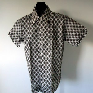 May include: A short-sleeved button-down shirt with a black and white diamond pattern.