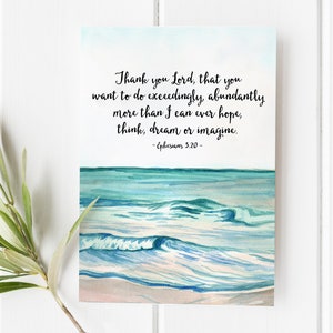 May include: A watercolor print featuring a serene ocean scene with waves in shades of blue and white. The artwork includes the text "Thank you Lord, that you want to do exceedingly, abundantly more than I can ever hope, think, dream or imagine." - Ephesians 3:20.
