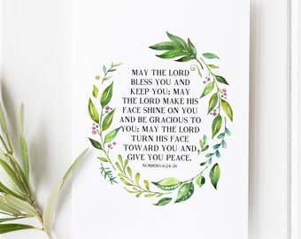 May include: A watercolour illustration of a leafy wreath with a white background. The wreath surrounds a bible verse from Numbers 6:24-26, which reads: "May the Lord bless you and keep you; may the Lord make his face shine on you and be gracious to you; may the Lord turn his face toward you and give you peace."