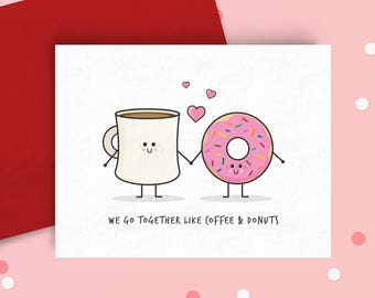 May include: A greeting card with a cartoon coffee cup and donut holding hands. The text on the card reads "We go together like coffee & donuts".