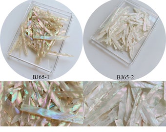 May include: Two containers of iridescent white mother of pearl shell flakes. The top two images show the flakes in the containers. The bottom two images show a close-up of the flakes. The containers are labeled BJ65-1 and BJ65-2.
