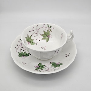 Antique Porcelain Cup and Saucer: Hand-Painted Floral Design