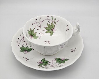 Antique Porcelain Cup and Saucer: Hand-Painted Floral Design