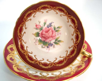 Aynsley Maroon Red and Gold Tea Cup and Saucer,  Red and gold Tea cup and Saucer with pink rose.