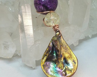 May include: A copper wire wrapped pendant with a purple and white stone bead and a iridescent copper teardrop shaped charm.