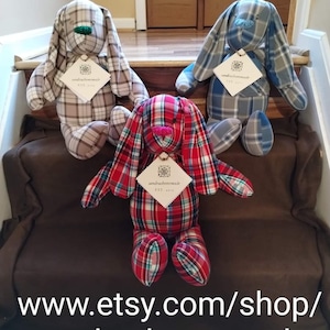 May include: Three handmade plaid bunny plushies in red and green, blue and gray, and brown and tan. Each bunny has a small tag with the text "sandrashomemade est. 2022".