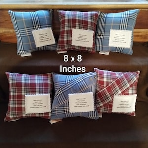 May include: Six square 8 x 8 inches plaid pillows in red and blue colorways. Each pillow features a white fabric patch with black printed text that reads: Made from a shirt I used to wear. Whenever you hold it, think of me there.
