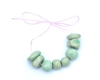 8 pieces of HandMade Ceramic Medium and Small  Beads in Various Shapes  in Mintgreen as shown on the pictures