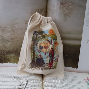 May include: A white cotton drawstring bag with a colorful illustration of a fairy scene. The illustration features a tree, a cauldron, a red-robed figure, and a sun. The bag is printed with the text "Free Range Fairies" and "artwork by Kate Monkman".