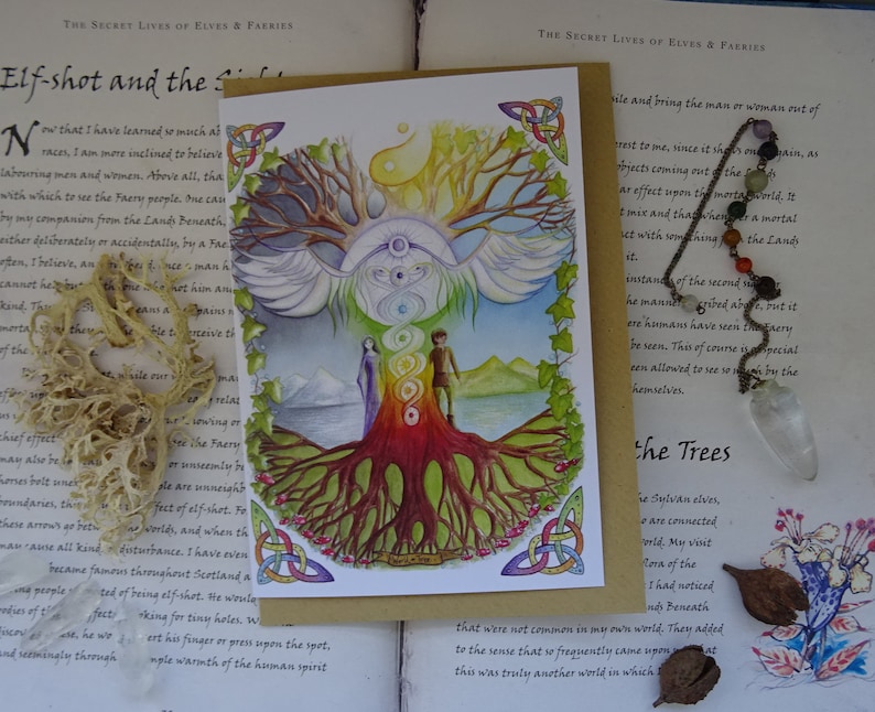 May include: A watercolor illustration of a tree with a rainbow-colored trunk and roots. The tree is surrounded by a white bird with wings spread. Two figures stand at the base of the tree, one male and one female. The illustration is on a white card with a brown border. The text "Elf-shot and the Sidhe" is written at the top of the card.