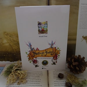 May include: A card with a whimsical illustration of fairies and gnomes surrounding a scroll with the text "Freelance Fairies" and a small image of a tree with the text "World Tree".
