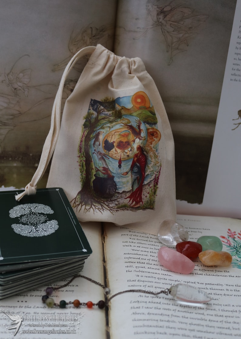 May include: A small, white drawstring bag with a colorful illustration of a tree and a woman. The bag is sitting on a book with a stack of green cards and a necklace with colorful beads. The book has text that reads "But usually people part of the Land Forest. Kee turned his green not like others within walk in at once in bet "How may that be astonished. For informed me of the notice that the air in still, quiet, almost breathey that characterizes the air the Subterranean realm. "It is really quite simple," replied Kee patiently. "There the that disguises our world is nature of all green"