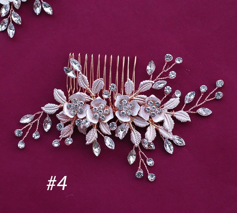 May include: Rose gold hair comb with floral and leaf detailing, embellished with clear crystals. The comb features three flower designs and is set against a deep burgundy background. The number "#4" is visible in the lower left corner.
