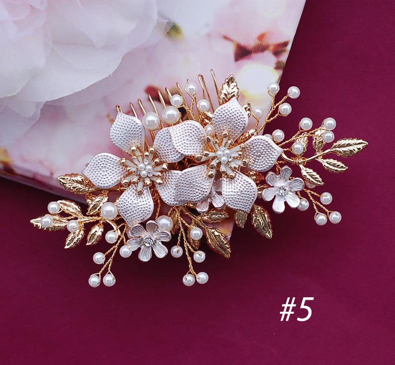 May include: A gold and silver floral hair comb with pearl accents. The comb features large, textured flowers, smaller blossoms, and delicate leaves. The number "5" is visible in the bottom right corner.