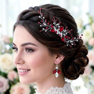 May include: A hair comb featuring silver-toned wire branches adorned with deep red teardrop crystals and small clear rhinestones, paired with a matching drop earring consisting of three red crystal petals and a single clear crystal accent.