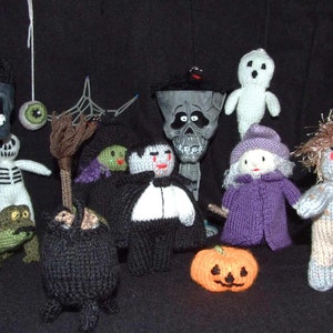 May include: A collection of knitted Halloween characters, including a ghost, a witch, a vampire, a skeleton, a frog, a cauldron, a pumpkin, and a monster.