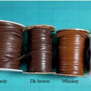 May include: Six spools of leather cord in various shades of brown, including Dark Chocolate Brown, Brandy, Dark Brown, Whiskey, Cognac, and Glazed Light Brown.